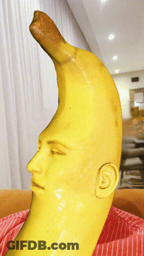 A Statue Of A Banana With A Face And Ear On It GIF