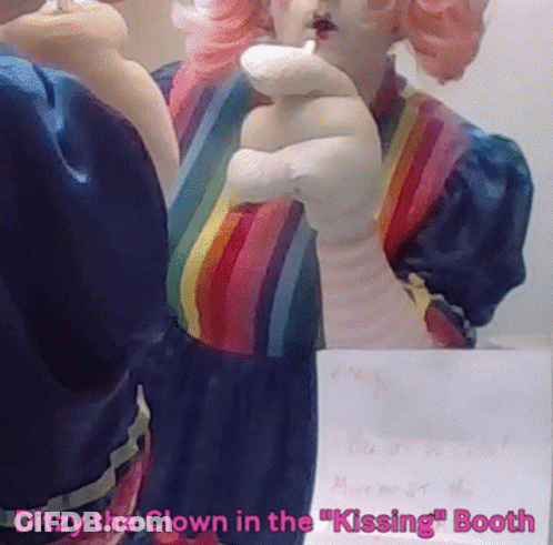 A Statue Of A Clown In A Rainbow Dress With The Words Ditzy The Clown In The Kissing Booth GIF