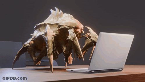 A Statue Of A Crab Looking At A Laptop On A Desk GIF