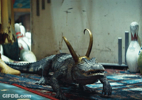 A Statue Of A Crocodile With A Crown On Its Head GIF