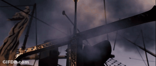 A Statue Of A Dragon Is Behind A Very Tall Pole That Says ' X ' GIF