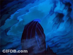 A Statue Of A Gargoyle Standing On Top Of A Rock GIF