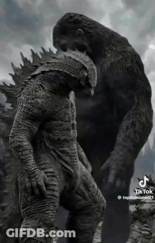 A Statue Of A Gorilla Standing Next To A Statue Of A Man With Armor GIF