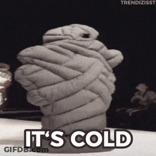 A Statue Of A Hand Wrapped In A Blanket With The Words It 'S Cold Above It GIF