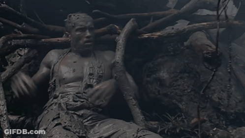 A Statue Of A Man Covered In Mud With The Word Jesus On His Chest GIF