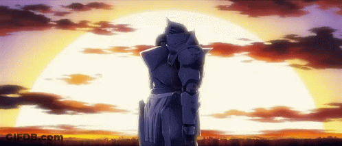 A Statue Of A Man In Armor Stands In Front Of A Sunset GIF