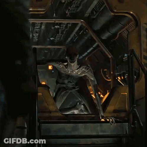 A Statue Of A Man Is Sitting On A Set Of Stairs With The Number 8 On It GIF