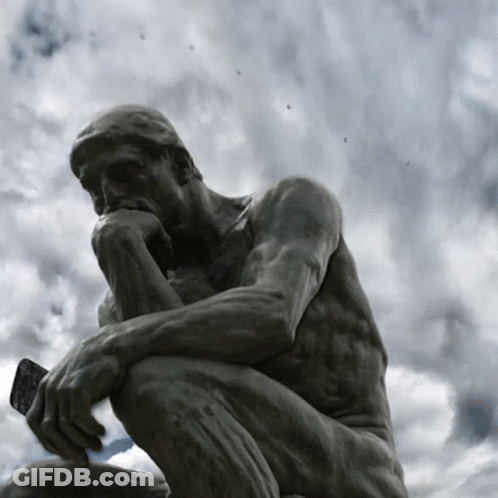 A Statue Of A Man Kneeling Down Thinking With A Cloudy Sky Behind Him GIF