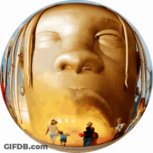 A Statue Of A Man 'S Face Is Reflected In A Gold Sphere GIF