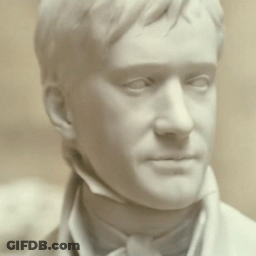 A Statue Of A Man 'S Face With His Eyes Closed GIF