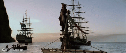 A Statue Of A Man Standing On Top Of A Ship In The Middle Of A Body Of Water GIF