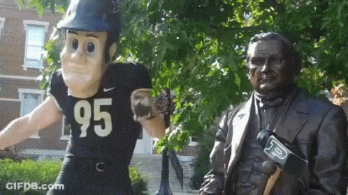 A Statue Of A Man Wearing A Number 95 Jersey GIF