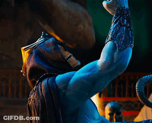 A Statue Of A Man With A Skull On His Face Is Holding Something In His Hand GIF