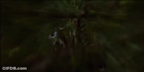 A Statue Of A Man With A Sword In His Hand Is Standing Next To A Tree GIF