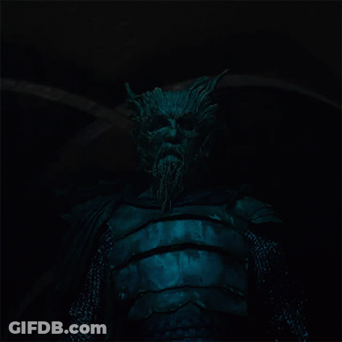 A Statue Of A Man With Horns And A Beard In The Dark GIF