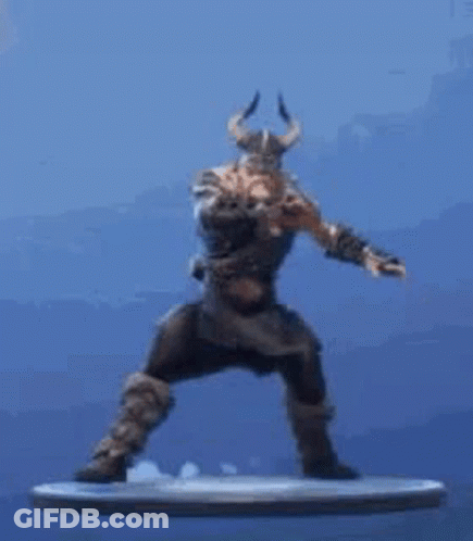 A Statue Of A Man With Horns Is Standing On A Platform . GIF