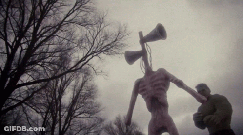 A Statue Of A Monster With A Megaphone In Its Head GIF