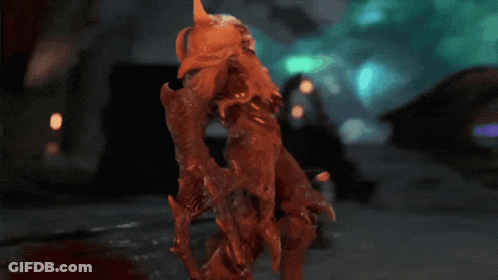 A Statue Of A Monster With Glowing Red Eyes And Sharp Teeth GIF