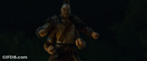 A Statue Of A Monster With His Mouth Open And Arms Outstretched In The Dark GIF