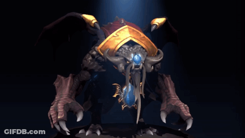 A Statue Of A Monster With Horns And A Blue Jewel In Its Mouth GIF