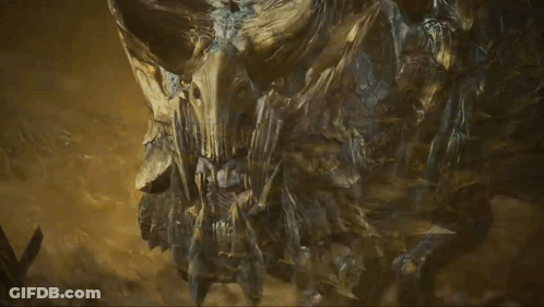 A Statue Of A Monster With Horns And A Face GIF