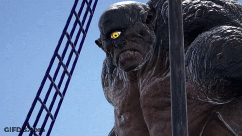 A Statue Of A Monster With Yellow Eyes Is Standing Next To A Ladder GIF