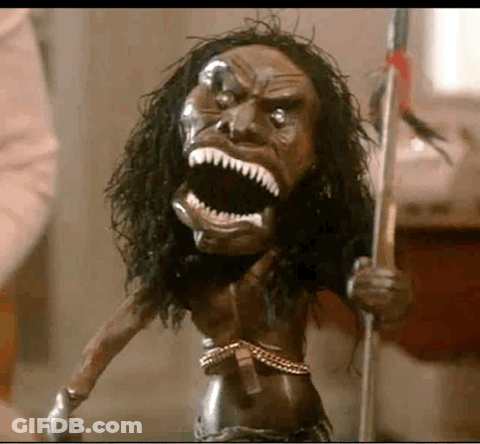 A Statue Of A Native American Holding A Spear With A Large Mouth . GIF