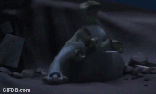 A Statue Of A Polar Bear Laying On Top Of A Rock In The Dark . GIF