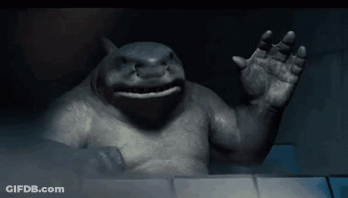 A Statue Of A Shark Is Waving Its Hand In The Dark GIF