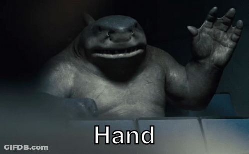 A Statue Of A Shark With The Word Hand Written Below It GIF