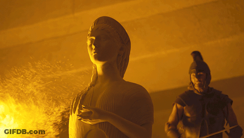 A Statue Of A Woman Standing Next To A Man GIF