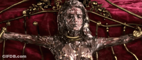 A Statue Of A Woman With A Necklace Around Her Neck GIF