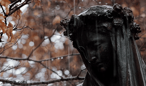 A Statue Of A Woman With A Veil On Her Head GIF