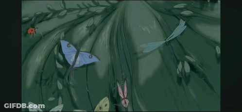 A Statue Of A Woman With Butterflies Flying Around It . GIF