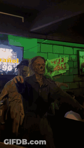A Statue Of A Zombie Wearing A Goggles And Holding A Yellow Sign With A Hand On It GIF