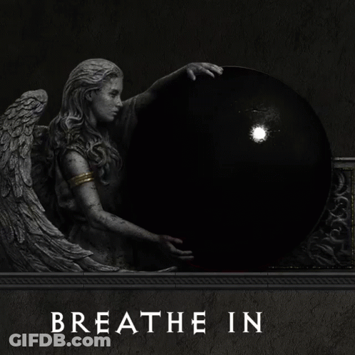 A Statue Of An Angel Holding A Red Ball With The Words Breathe Out Underneath It GIF