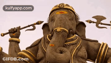 A Statue Of An Elephant Holding A Trident And An Arrow GIF