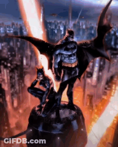 A Statue Of Batman And Catwoman Standing Next To Each Other In Front Of A City . GIF