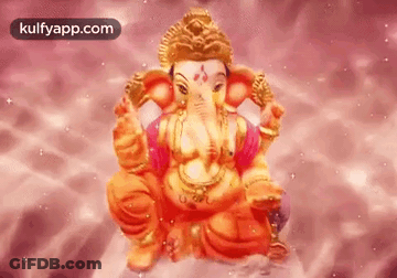 A Statue Of Ganesha Is Sitting On A Pink Surface . GIF