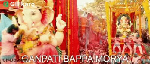 A Statue Of Ganpati Is Being Paraded Through A Crowd Of People At A Festival In India . GIF