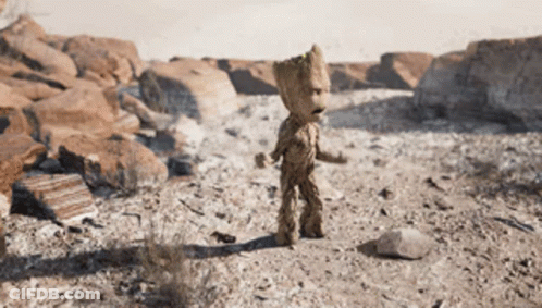 A Statue Of Groot Is Standing In A Desert GIF