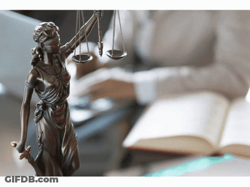 A Statue Of Lady Justice With Scales And A Sword GIF