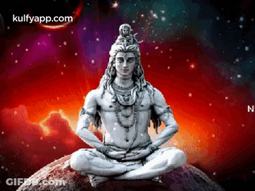 A Statue Of Lord Shiva Is Sitting On Top Of A Rock In A Lotus Position . GIF