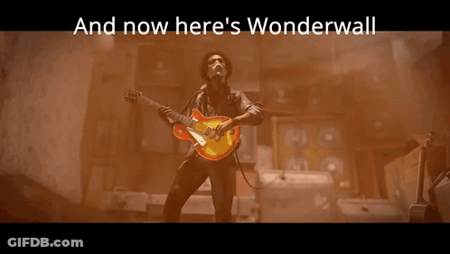 A Statue With The Words And Now Here 'S Wonderwall Behind It GIF