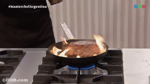 A Steak Is Being Cooked In A Frying Pan On A Stove With The Hashtag Masterchefargentina GIF