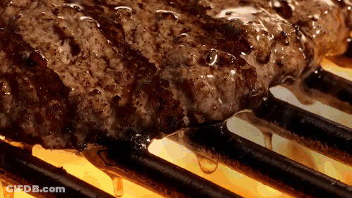 A Steak Is Cooking On A Grill With A Lot Of Liquid Dripping Off Of It GIF