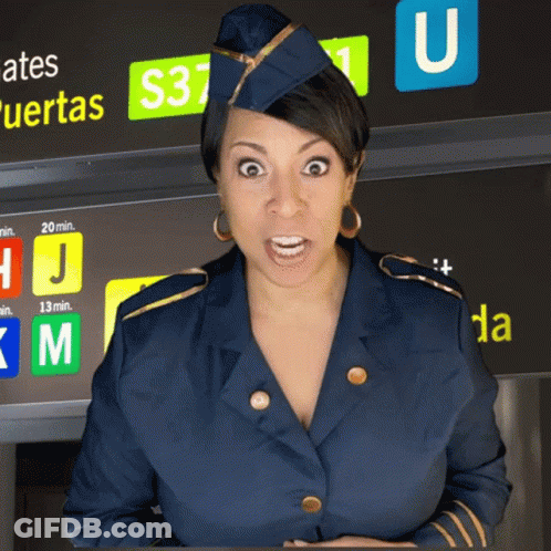 A Stewardess Stands In Front Of A Sign That Says Gates Puertas GIF