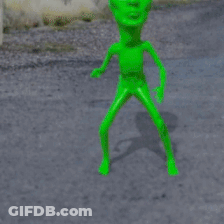 A Stop Sign With A Green Alien In Front Of It GIF