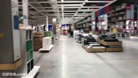 A Store Aisle With A Sign That Says Exit On It GIF