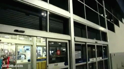 A Store Front With A Sliding Glass Door That Says Exit GIF